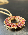 sapphire bead pendant with concentric circles of 14k gold