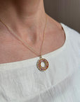 sapphire bead pendant with concentric circles of 14k gold