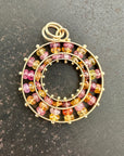 sapphire bead pendant with concentric circles of 14k gold