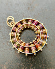 sapphire bead pendant with concentric circles of 14k gold