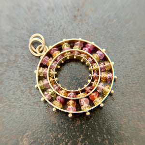 sapphire bead pendant with concentric circles of 14k gold