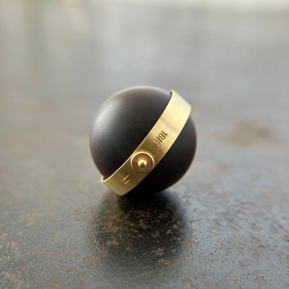saturn agate orb with bands of color set in 18k gold