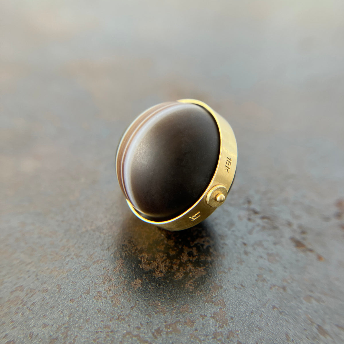 saturn agate orb with bands of color set in 18k gold