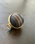 saturn agate orb with bands of color set in 18k gold