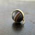 saturn agate orb with bands of color set in 18k gold