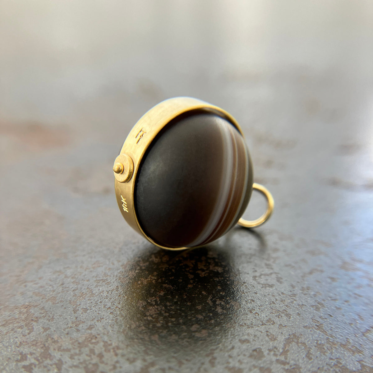 saturn agate orb with bands of color set in 18k gold