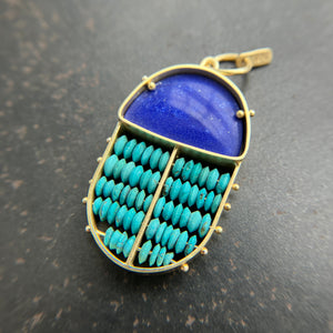 scarab shaped pendants of 18k gold, lapis, and turquoise beads