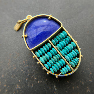 scarab shaped pendants of 18k gold, lapis, and turquoise beads