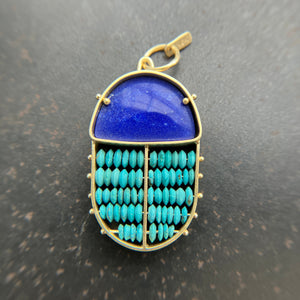 scarab shaped pendants of 18k gold, lapis, and turquoise beads