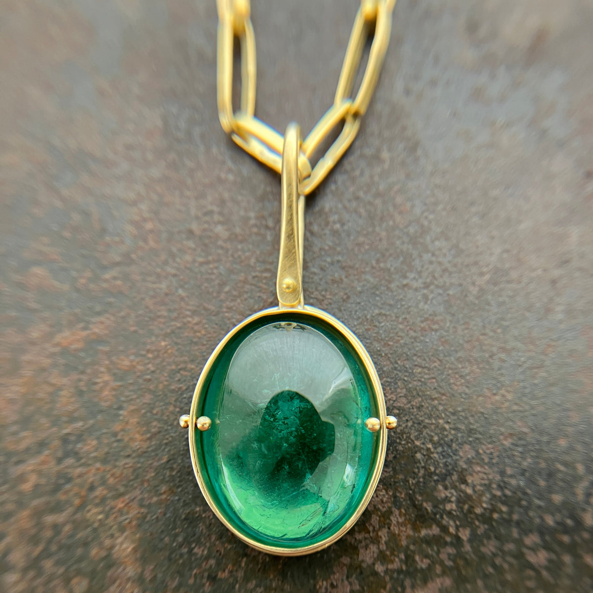 teal green tourmaline oval pendant in 18k gold with an 18k gold chain