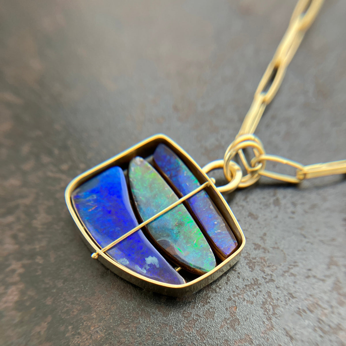 blue and green boulder opal pendant in 18k gold