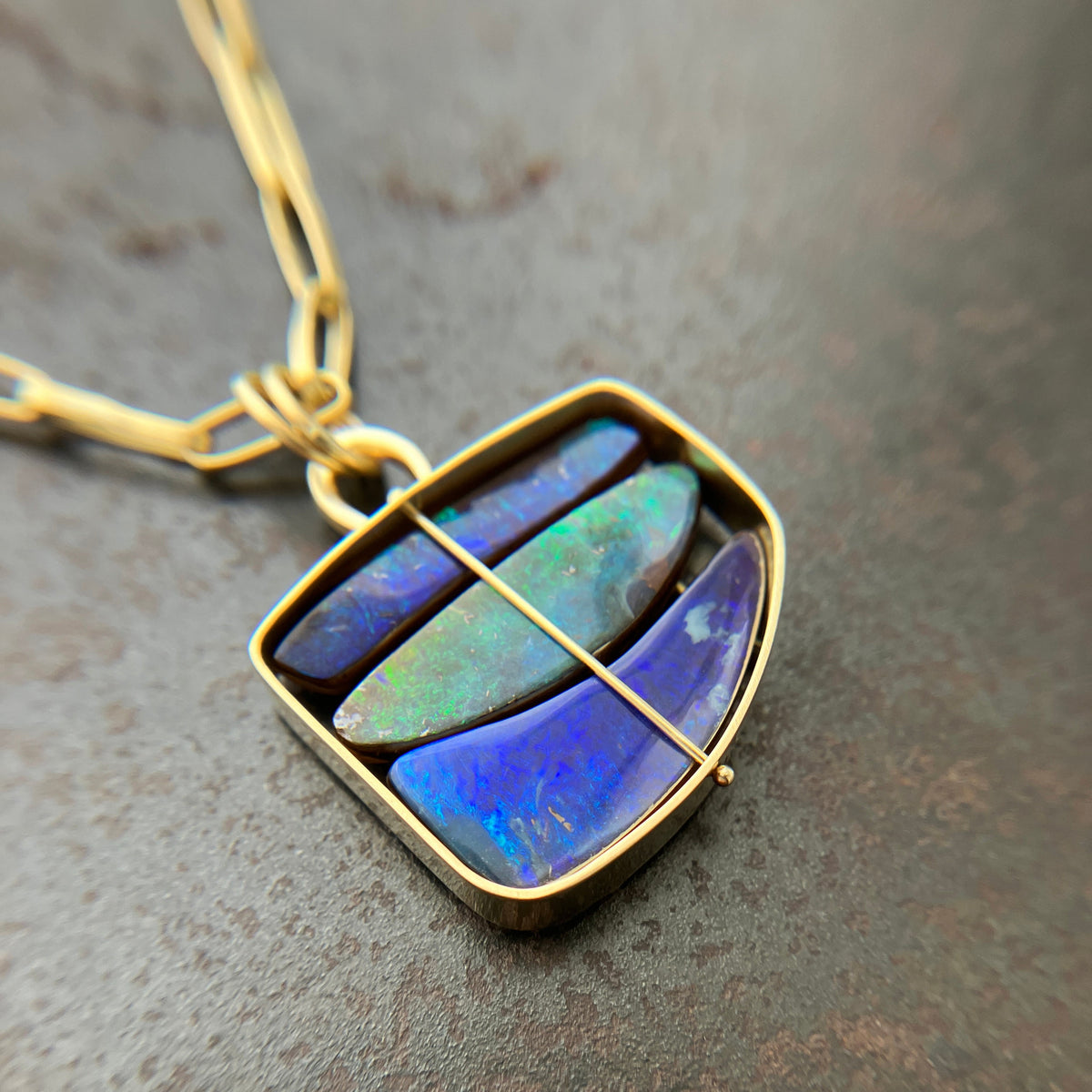blue and green boulder opal pendant in 18k gold