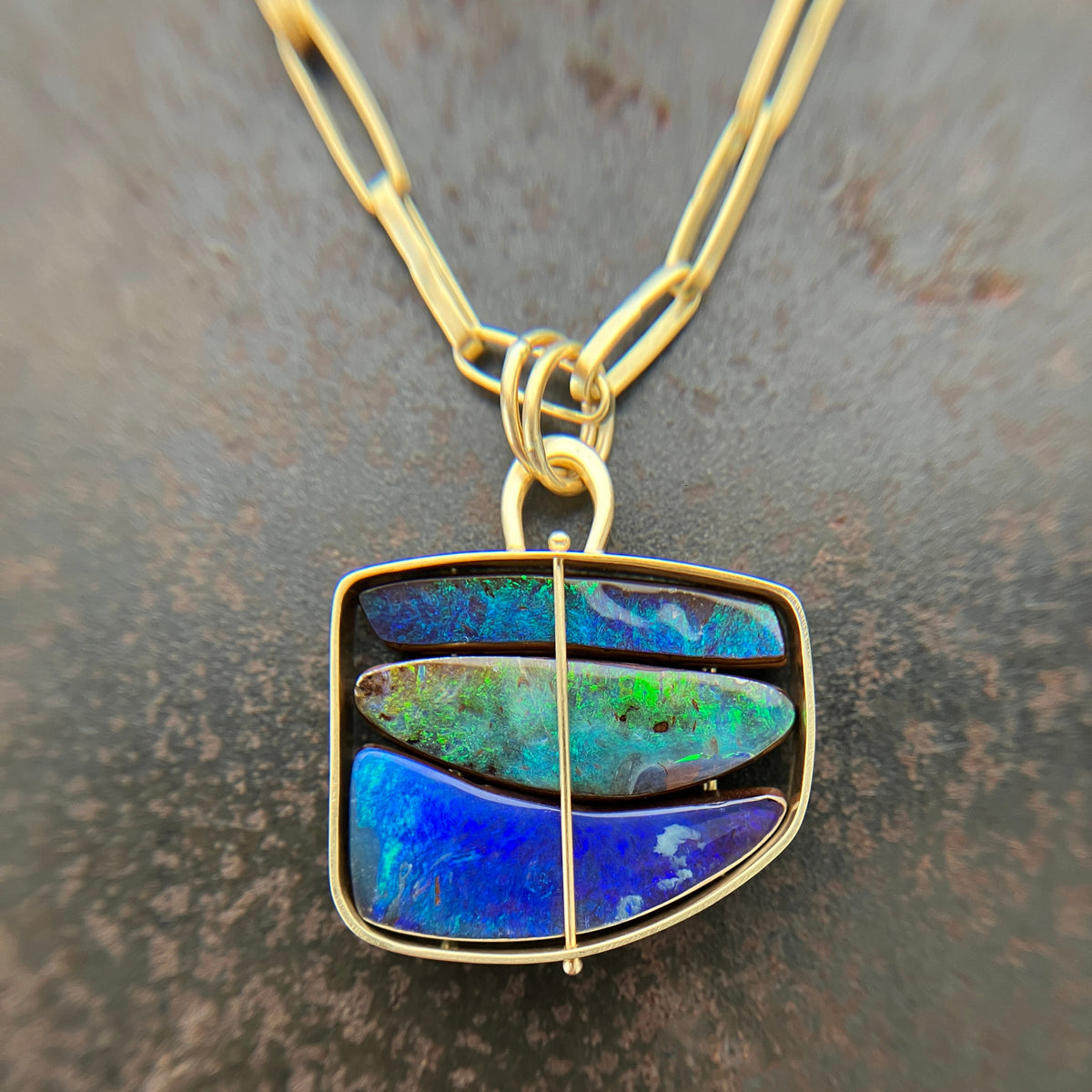 blue and green boulder opal pendant in 18k gold