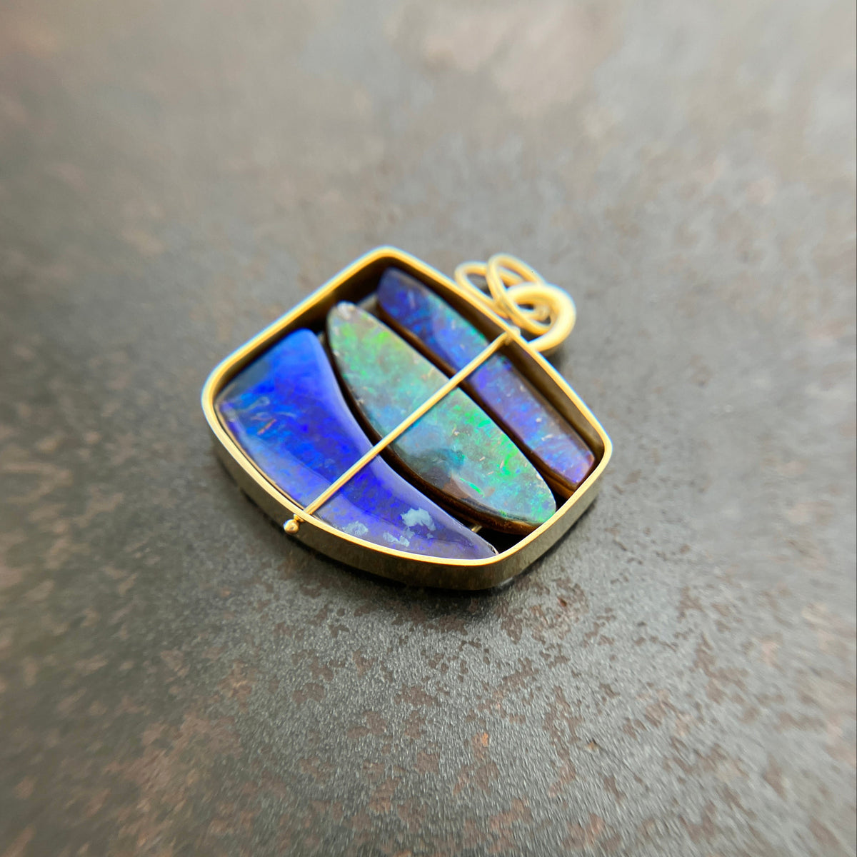 blue and green boulder opal pendant in 18k gold