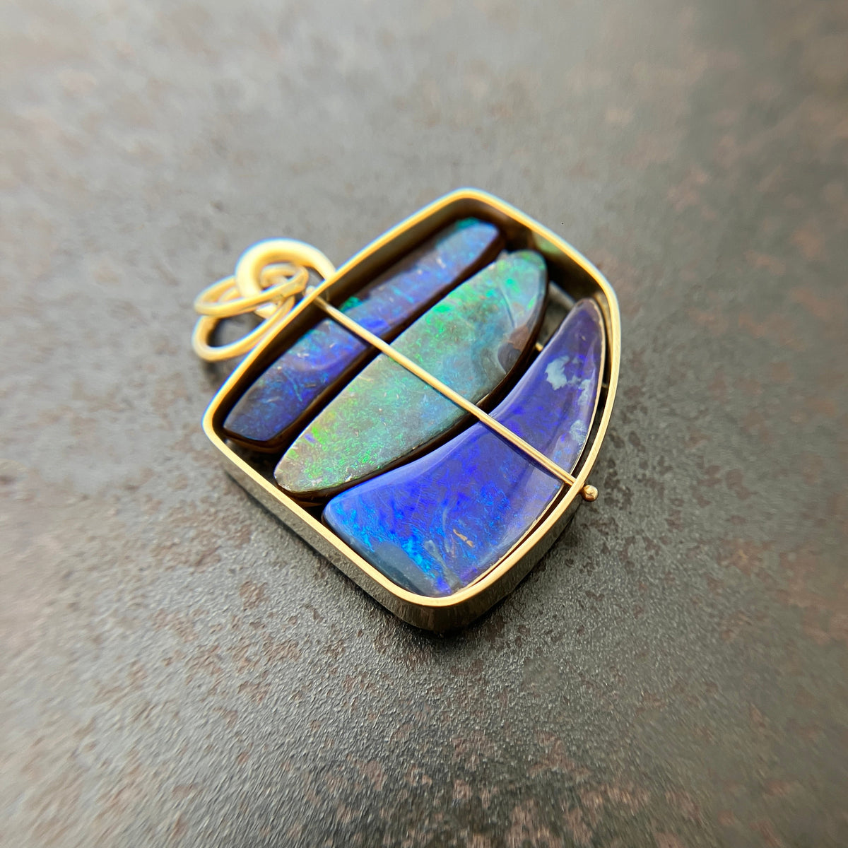 blue and green boulder opal pendant in 18k gold