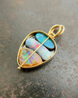 blue white and brown boulder opals set in an 18k gold frame