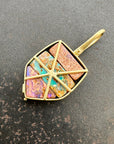 A shield-shaped pendant featuring an 18k gold frame and three rectangular inlay wood replacement opals in pink, turquoise, purple, and brown.