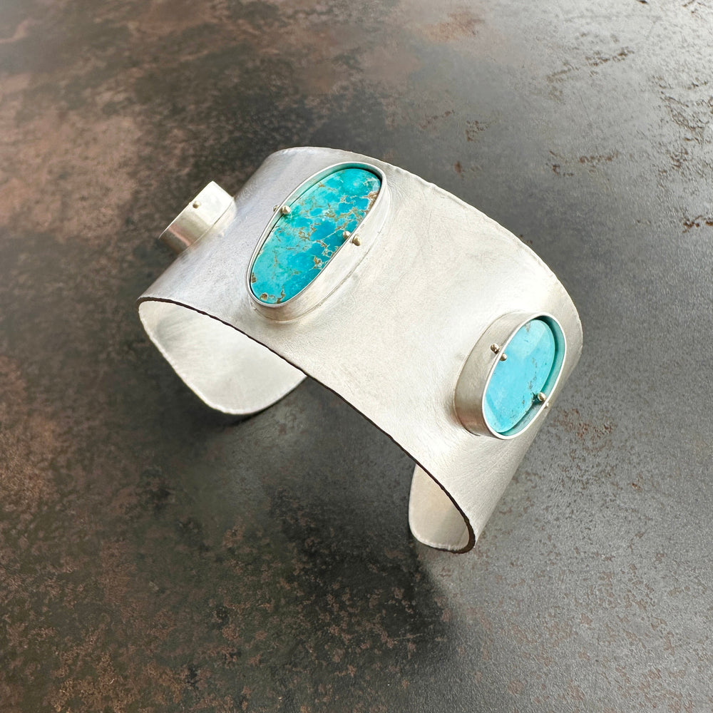silver cuff bracelet with three turquoise stones