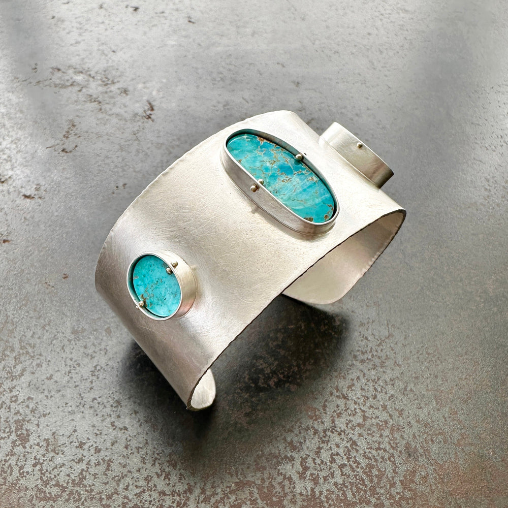 silver cuff bracelet with three turquoise stones
