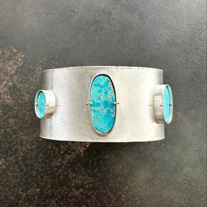silver cuff bracelet with three turquoise stones