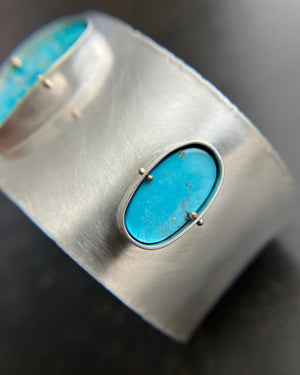 silver cuff bracelet with three turquoise stones