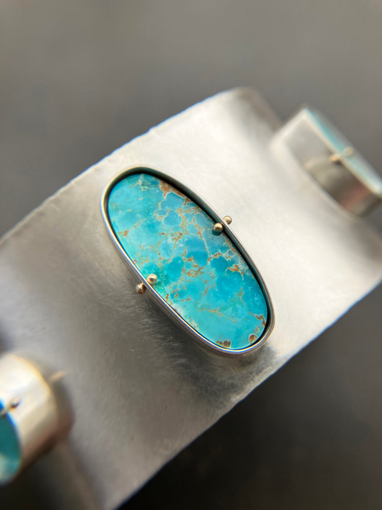 silver cuff bracelet with three turquoise stones