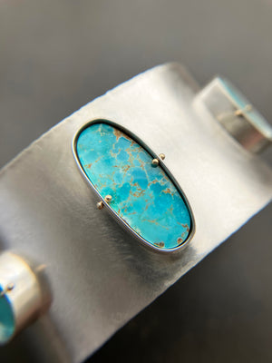 silver cuff bracelet with three turquoise stones
