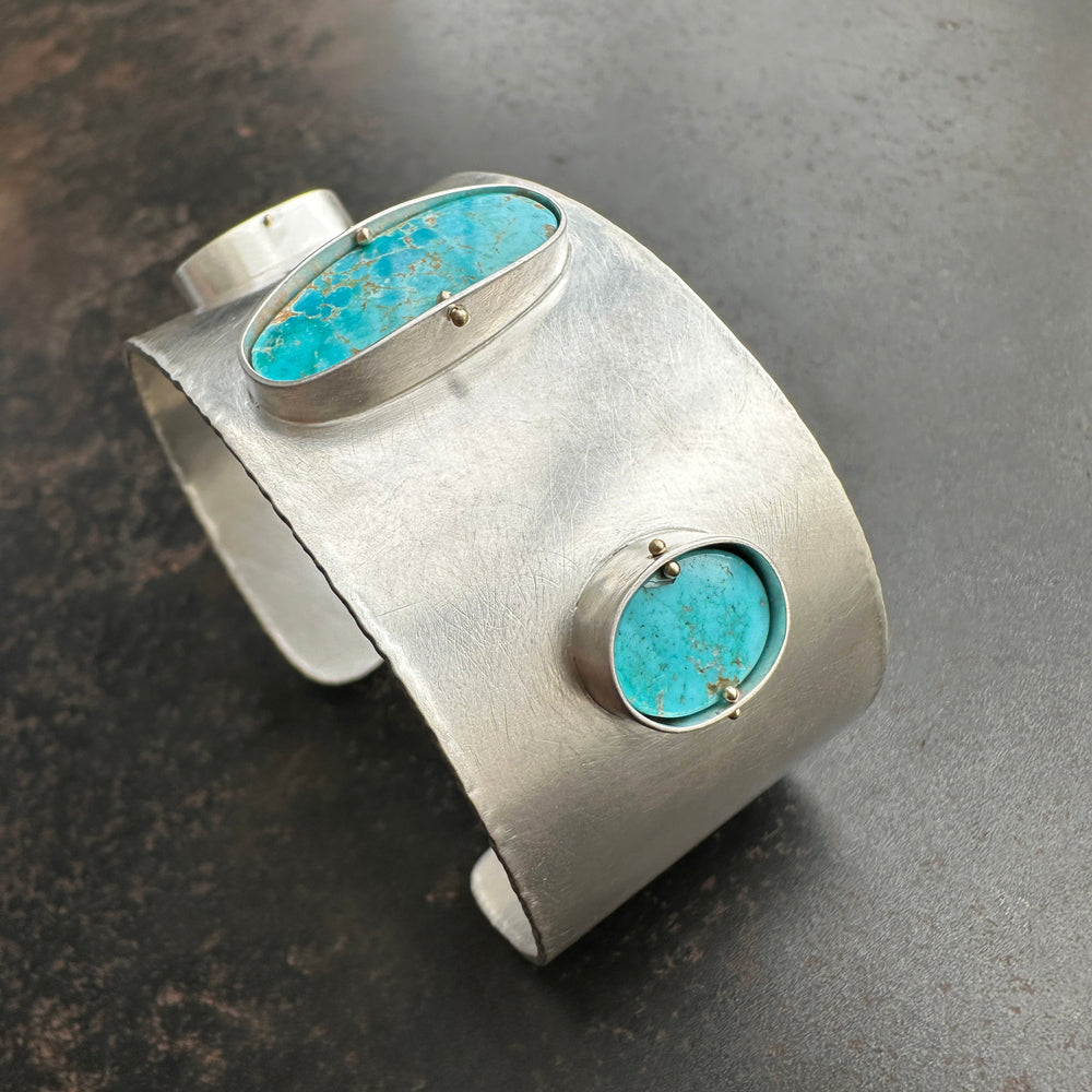 silver cuff bracelet with three turquoise stones