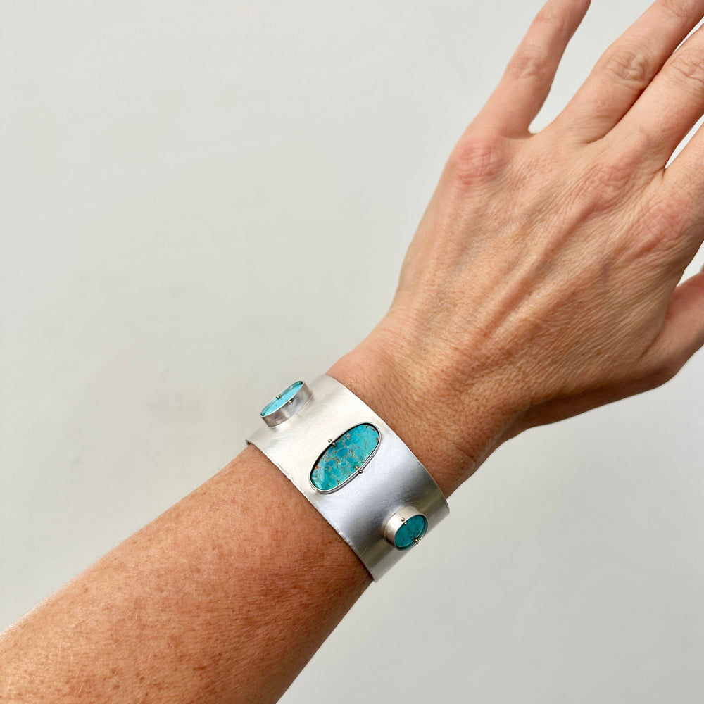 silver cuff bracelet with three turquoise stones