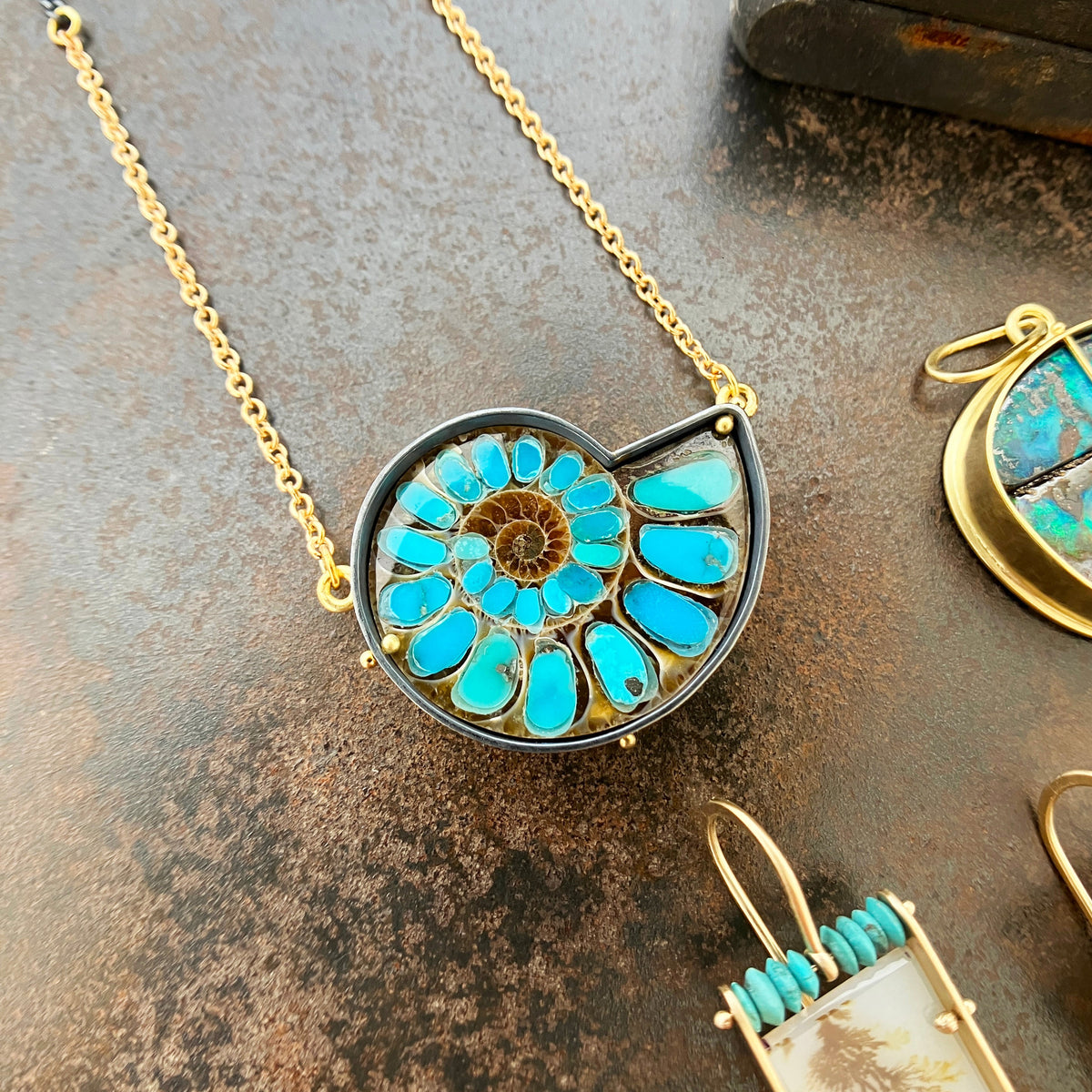 ammonite with embedded turquoise necklace in silver and gold on silver and gold chain