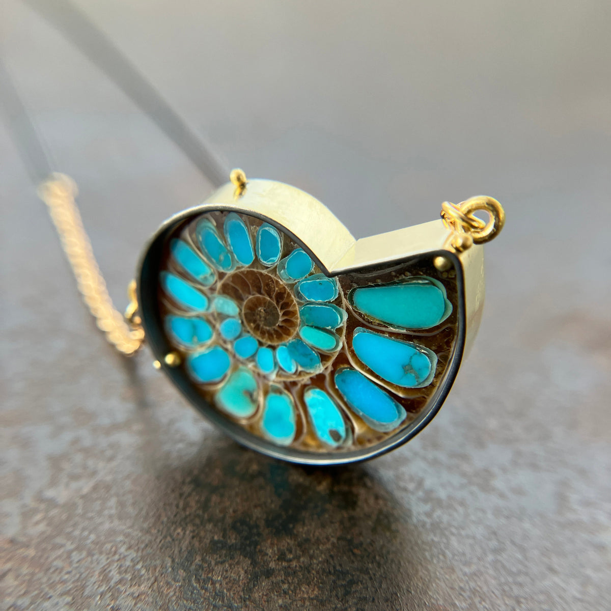 ammonite with embedded turquoise necklace in silver and gold on silver and gold chain