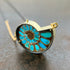 ammonite with embedded turquoise necklace in silver and gold on silver and gold chain