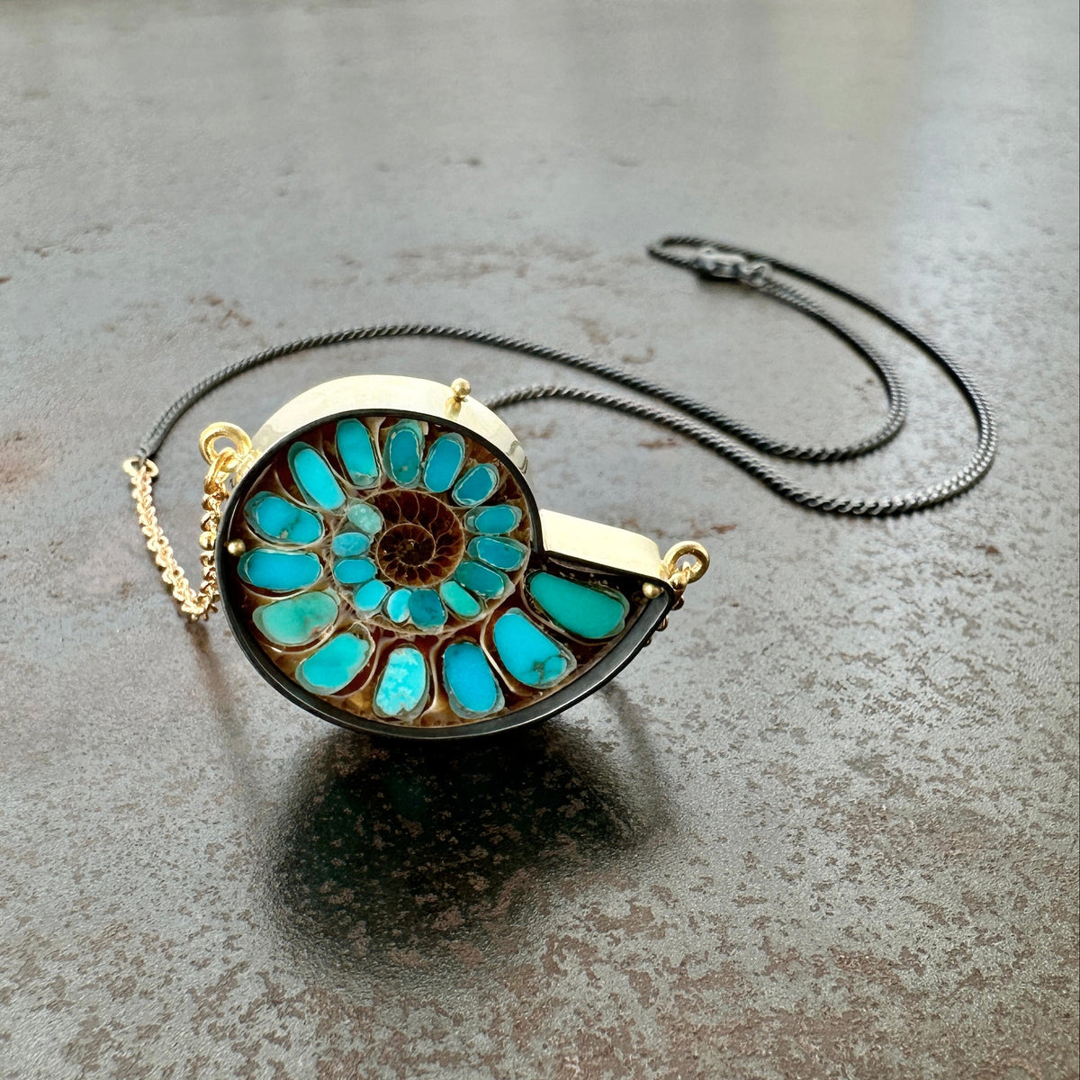 ammonite with embedded turquoise necklace in silver and gold on silver and gold chain