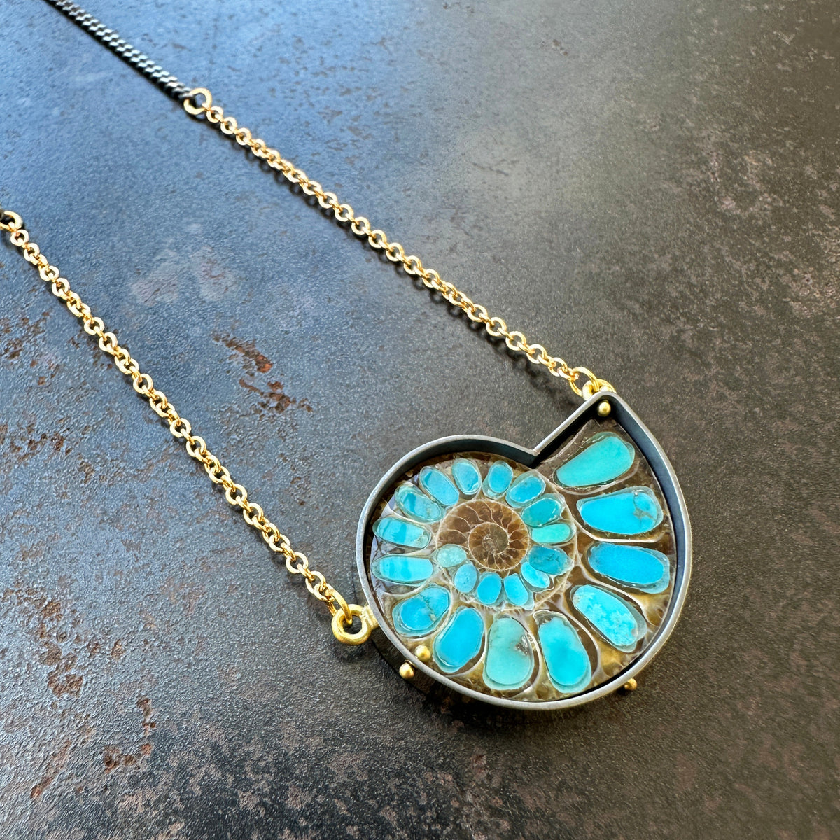 ammonite with embedded turquoise necklace in silver and gold on silver and gold chain