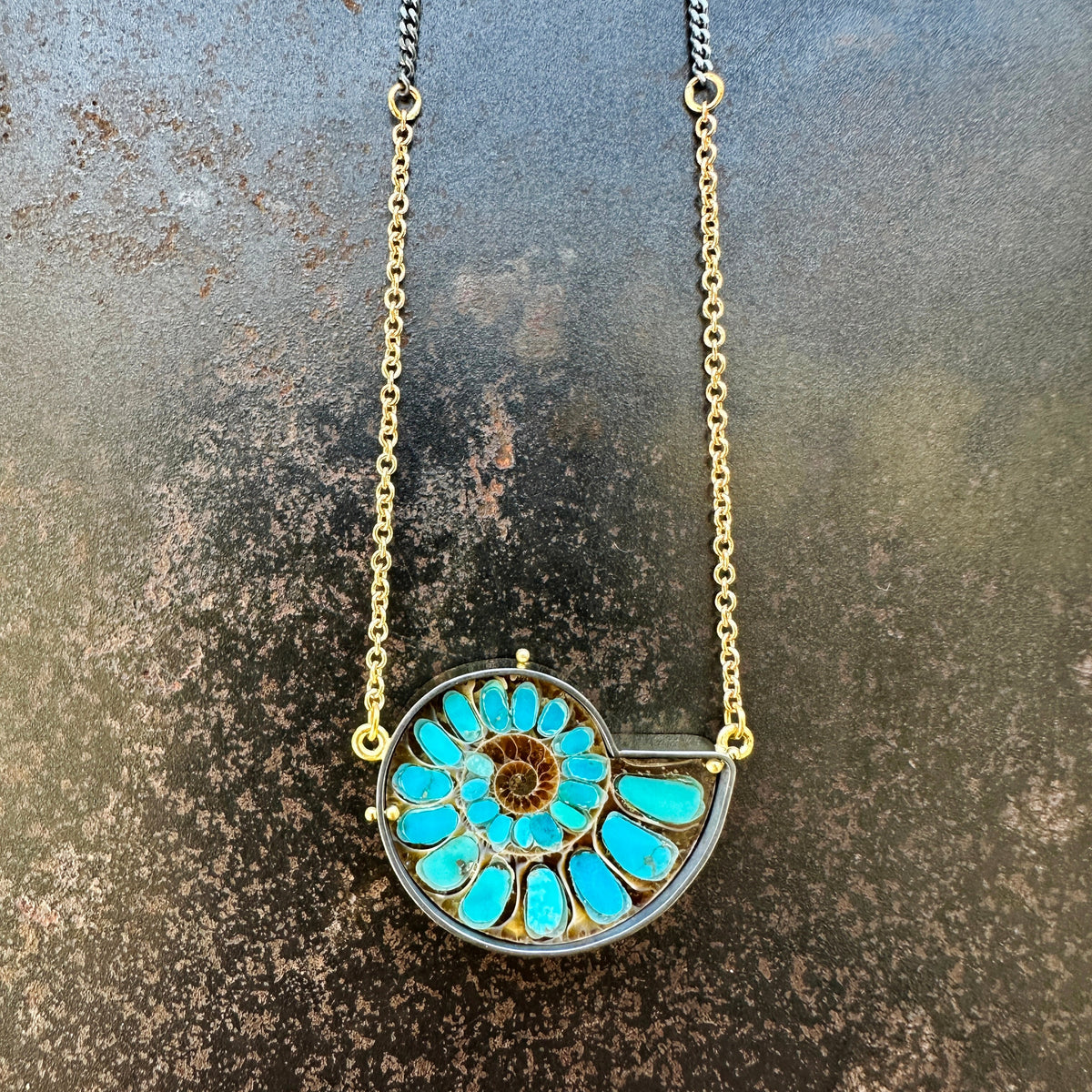 ammonite with embedded turquoise necklace in silver and gold on silver and gold chain