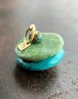 chinese hand carved turquoise beads with an 18k gold bale.