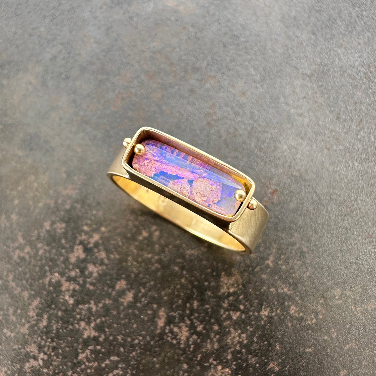 purple wood opal set in an 8k gold ring