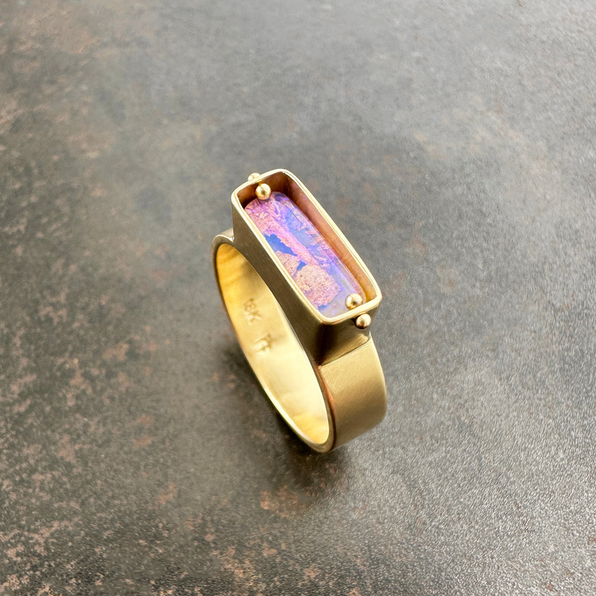 purple wood opal set in an 8k gold ring