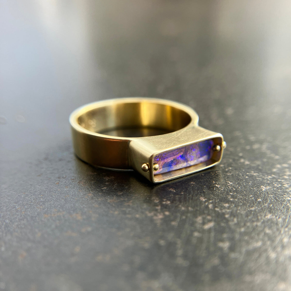 purple wood opal set in an 8k gold ring