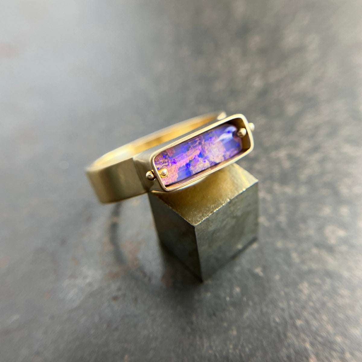 purple wood opal set in an 8k gold ring