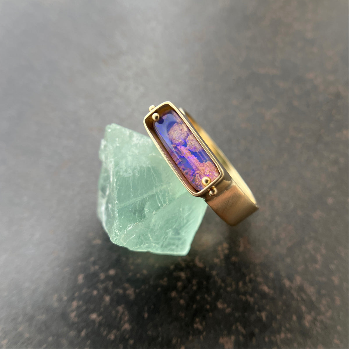purple wood opal set in an 8k gold ring