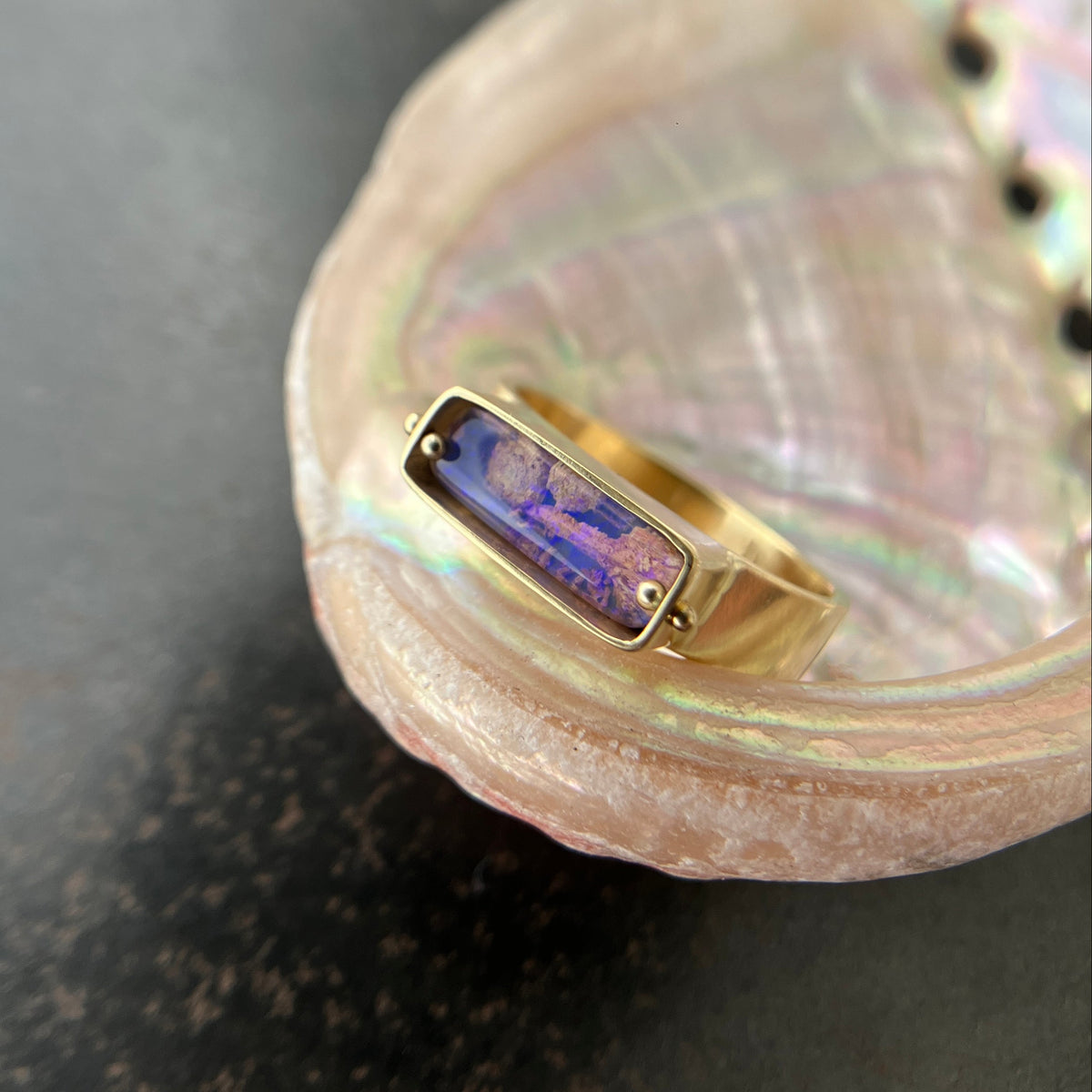 purple wood opal set in an 8k gold ring