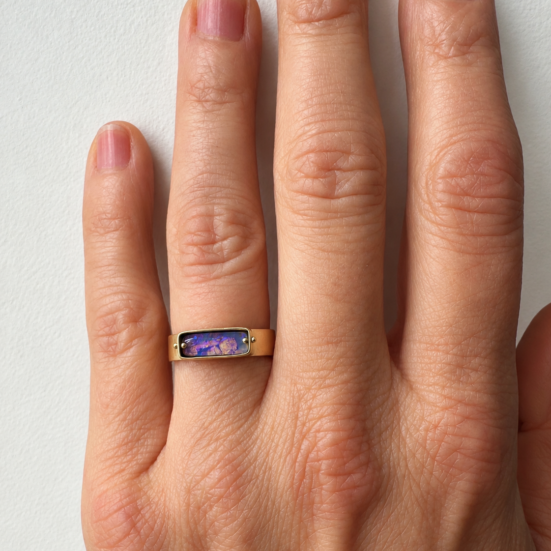 purple wood opal set in an 8k gold ring