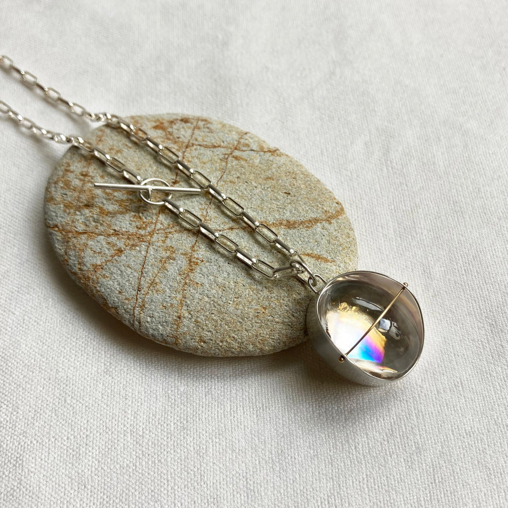 
                
                    Load image into Gallery viewer, rainbow quartz necklace in sterling silver with a 14k gold crossbar
                
            